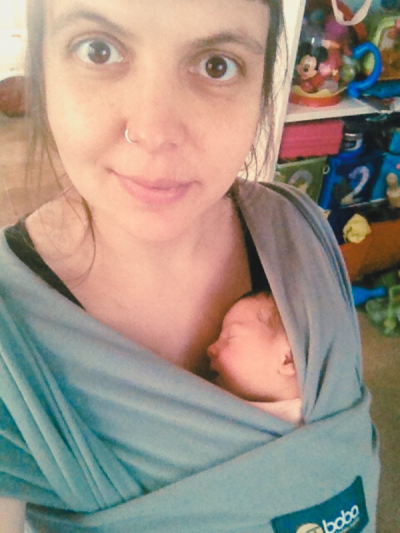 Bibiana carrying one of her daughters as a baby on a sling